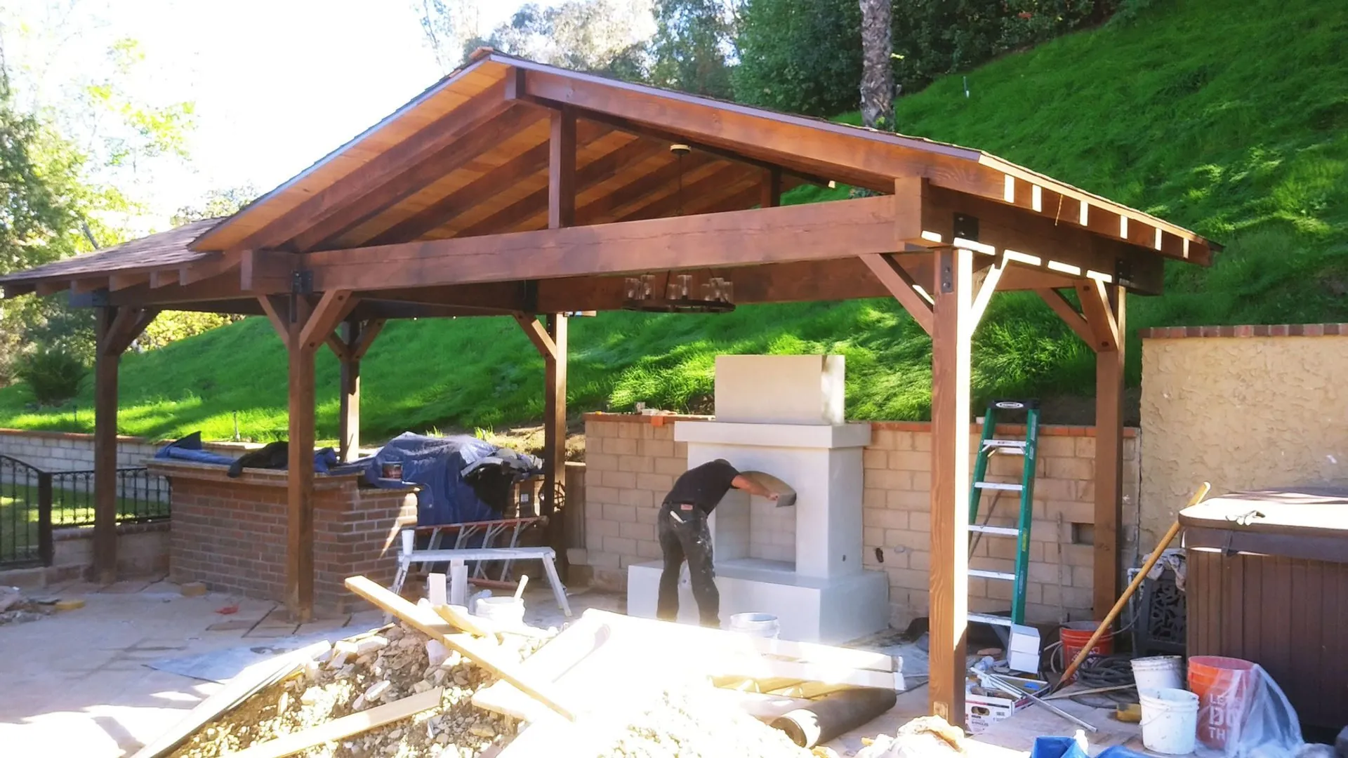 Heavy timber pavilion with masonry outdoor kitchen under construction